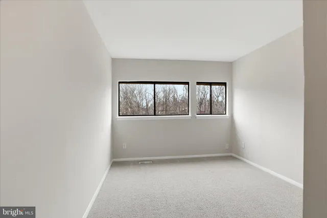 a bathroom with a granite countertop sink a toilet and a mirror