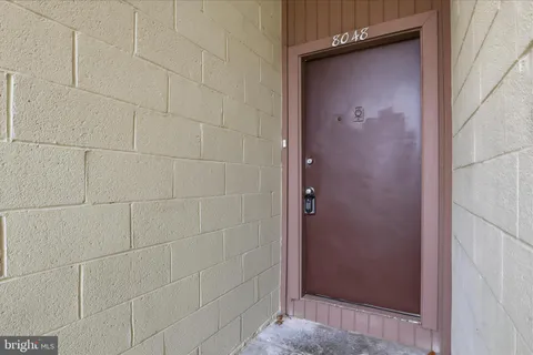 a view of staircase with wooden floor and white walls