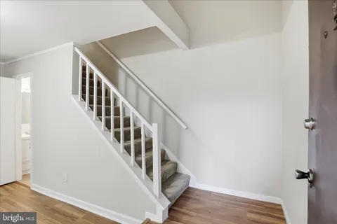 a living room with furniture a flat screen tv and a large window