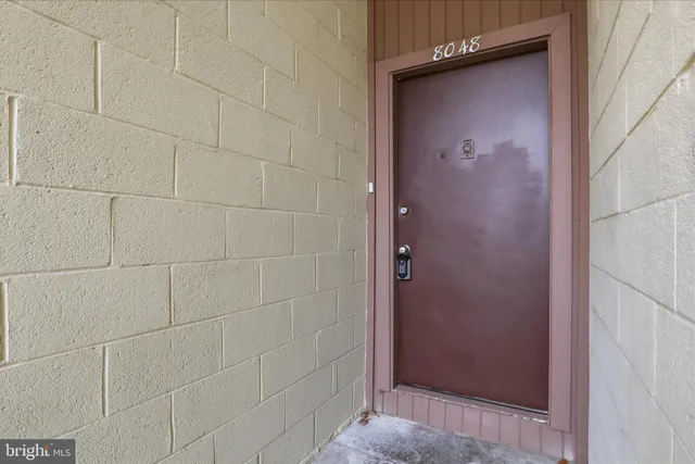 a view of staircase with wooden floor and white walls