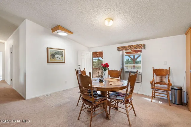 a view of a dining room with furniture and a potted plant