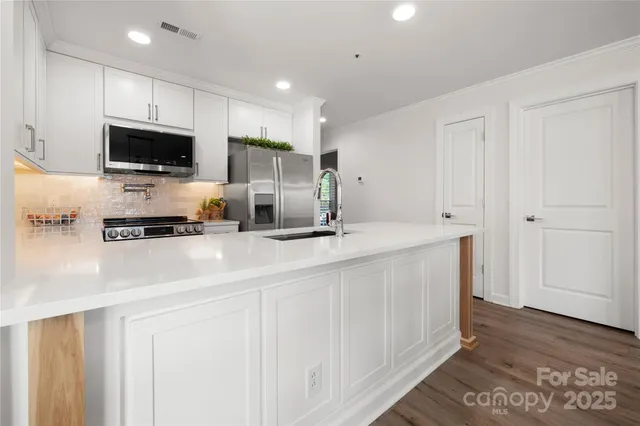 a kitchen with a refrigerator and a sink