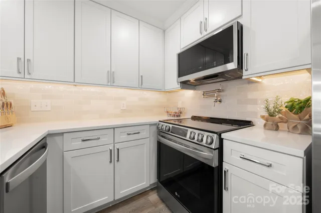 a kitchen with sink cabinets and wooden floor