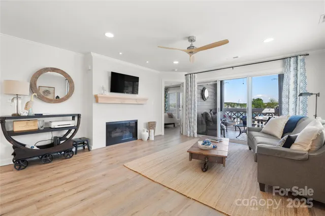 a living room with furniture windows and a wooden floor