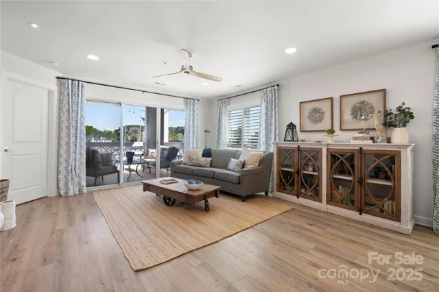 a view of living room with furniture and wooden floor