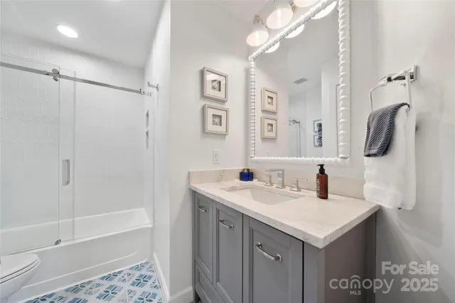 a bathroom with a sink vanity and a mirror