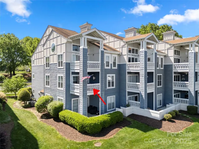 a view of a building with a yard and plants