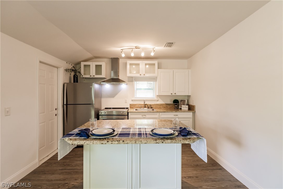2502 Lake Trafford Road Immokalee, FL 34142 - Photo 12 of 15 a kitchen with a stove a refrigerator and cabinets