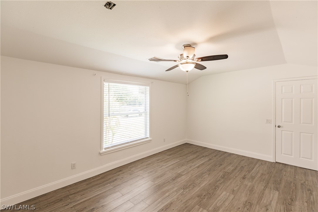2502 Lake Trafford Road Immokalee, FL 34142 - Photo 14 of 15 wooden floor in an empty room with a window