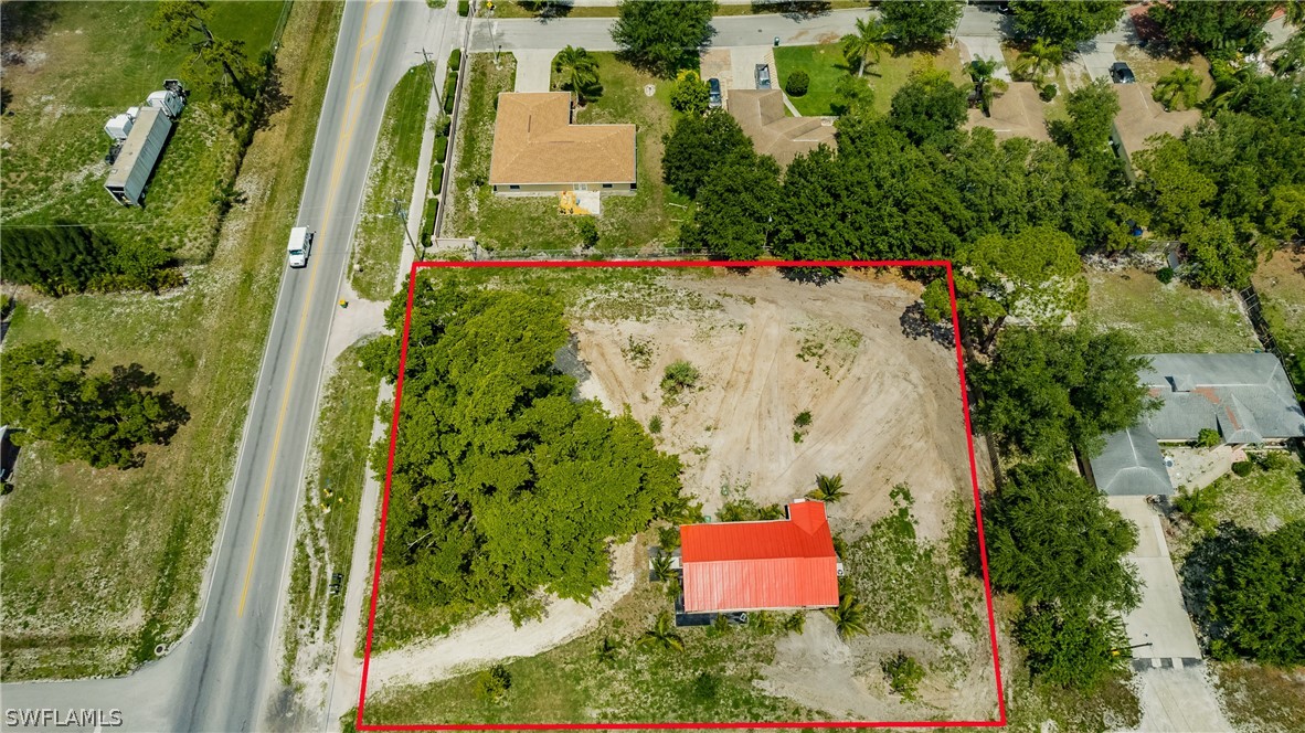 2502 Lake Trafford Road Immokalee, FL 34142 - Photo 3 of 15 an aerial view of a house with a yard and trees