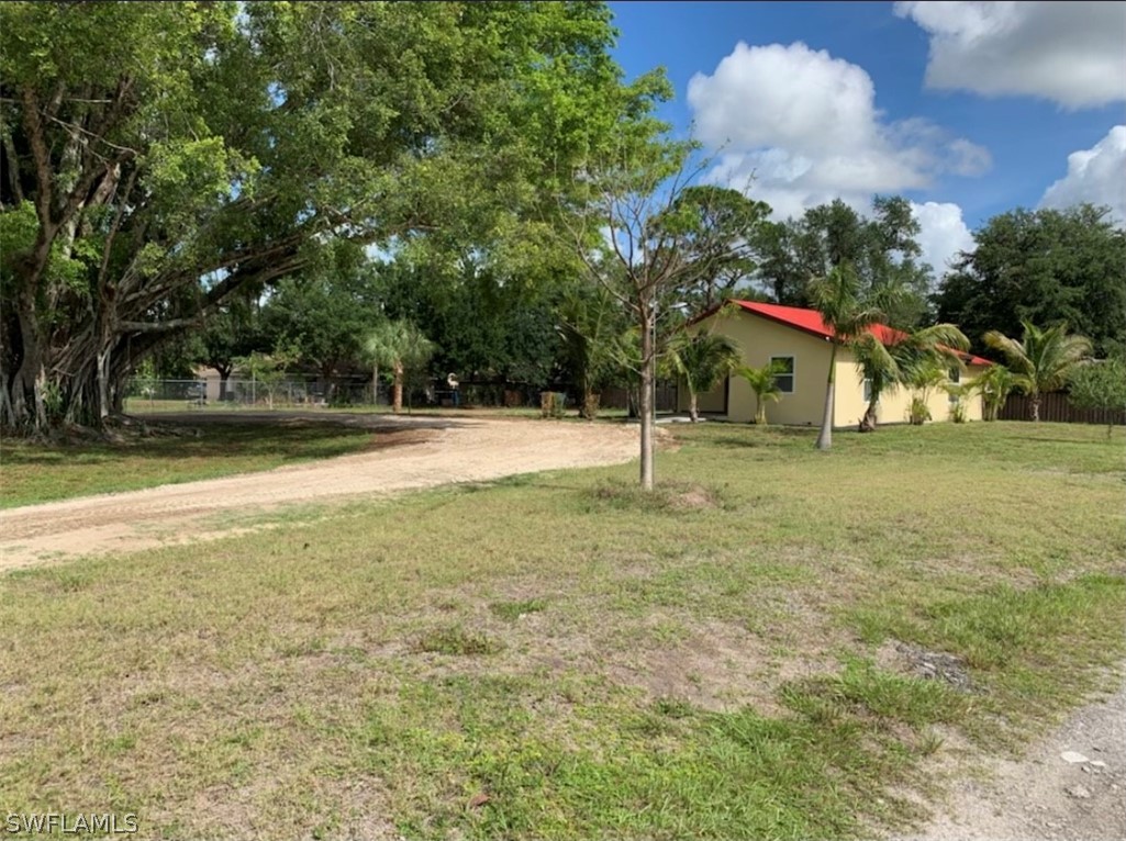 2502 Lake Trafford Road Immokalee, FL 34142 - Photo 7 of 15 a backyard of a house with lots of green space