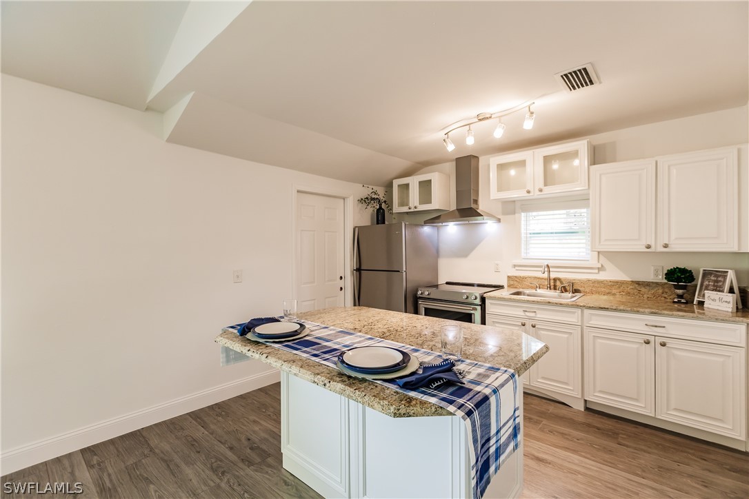 2502 Lake Trafford Road Immokalee, FL 34142 - Photo 10 of 15 a kitchen with a stove and cabinets