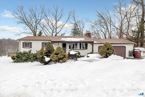 a view of a house with snow in front of house