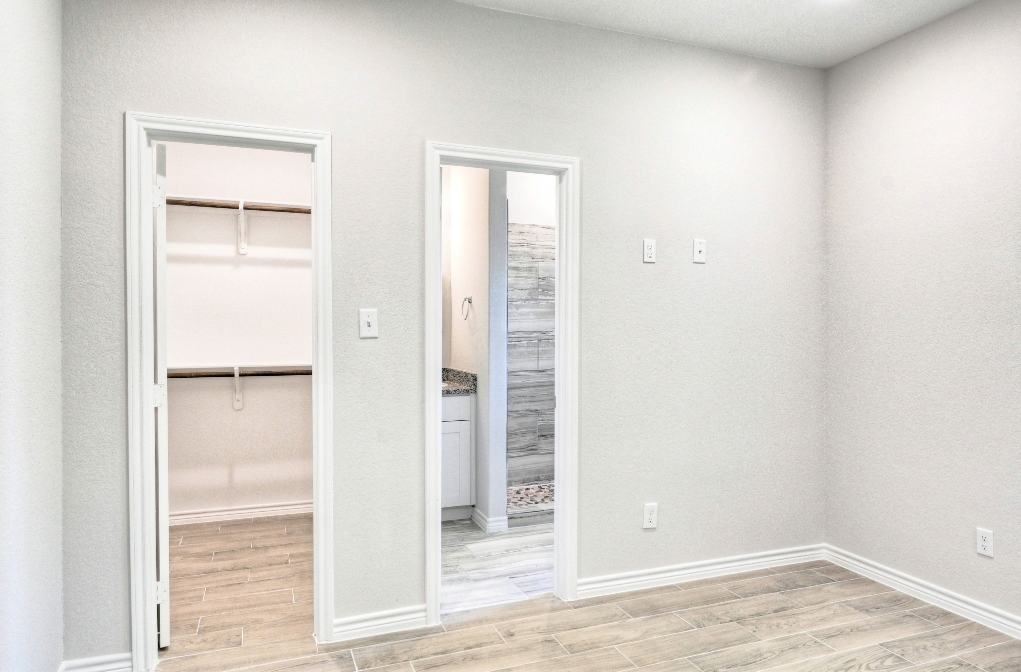 9810 Arbor Oak Willis, TX 77318 - Photo 21 of 43 an empty room with wooden floor closet and windows