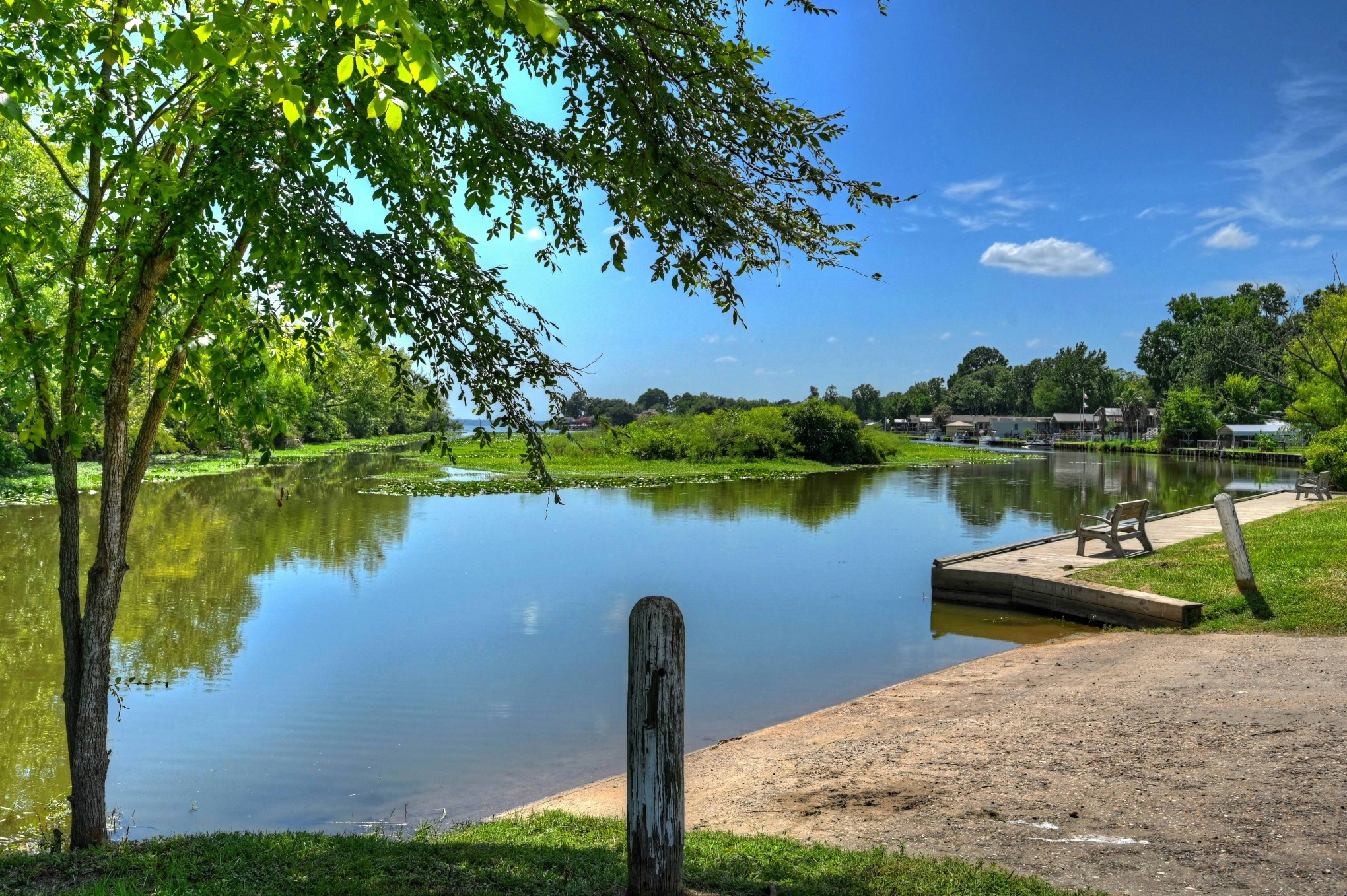 9810 Arbor Oak Willis, TX 77318 - Photo 35 of 43 a view of a lake with a yard and large trees