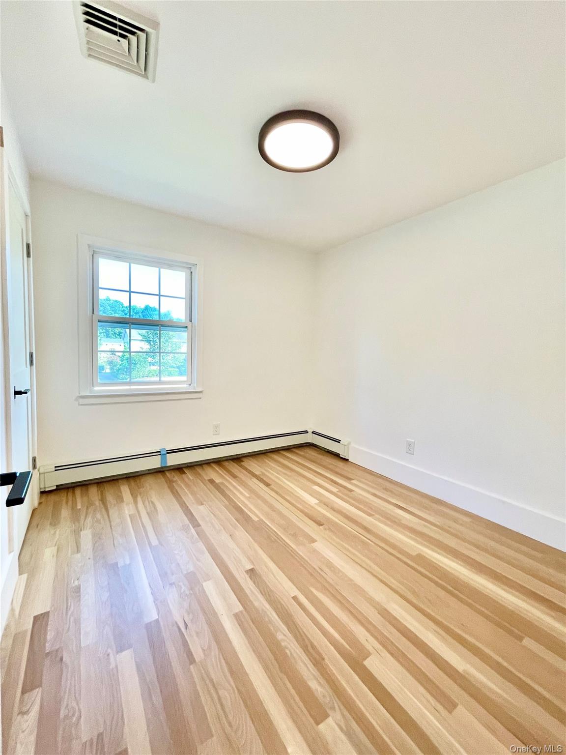 10 Frederick Middletown, NY 10941 - Photo 22 of 38 an empty room with wooden floor and windows