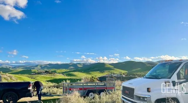 an aerial view of ocean with residential houses with outdoor space