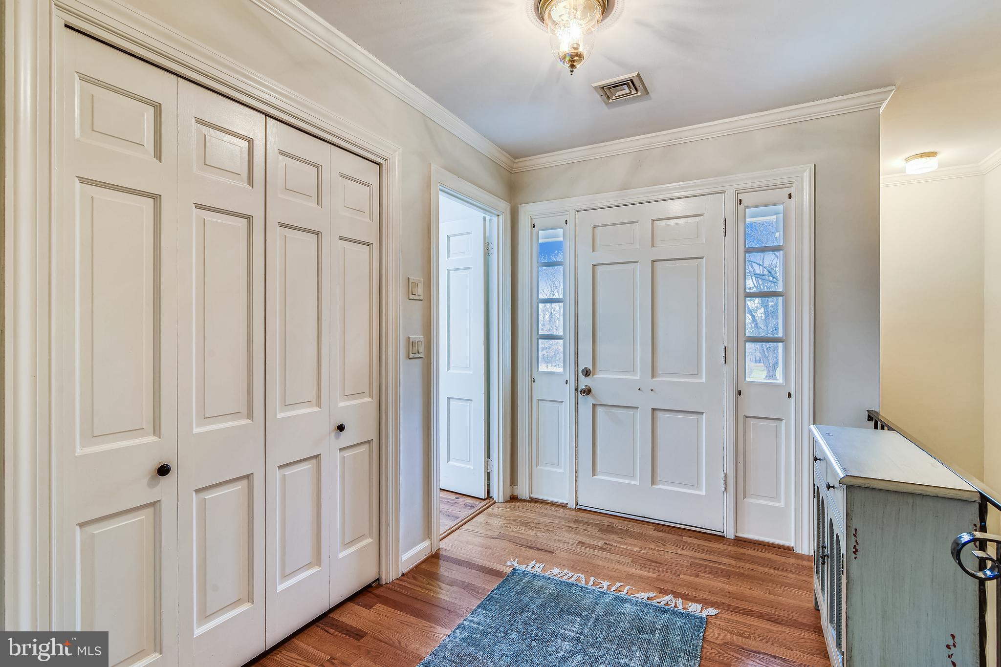 19366 Loudoun Orchard Road Leesburg, VA 20175 - Photo 8 of 40 Hardwood flooring reflecting light in the foyer