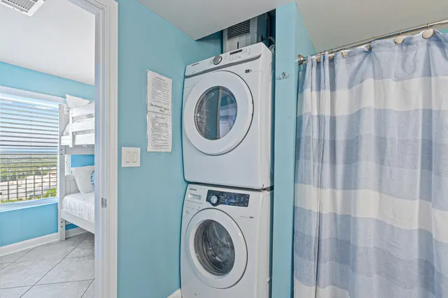 a view of a bedroom with washer and dryer