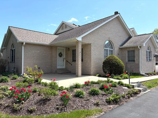 a front view of house and flowers