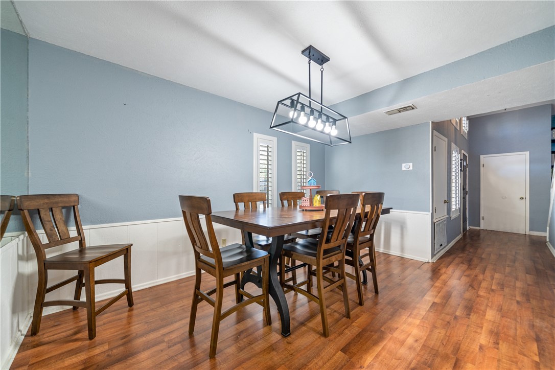2217 Post Oak Drive Portland, TX 78374 - Photo 15 of 39 a view of a dining room with furniture and wooden floor