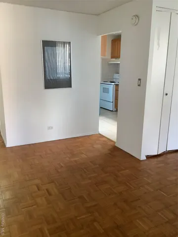 a view of an empty room and closet area