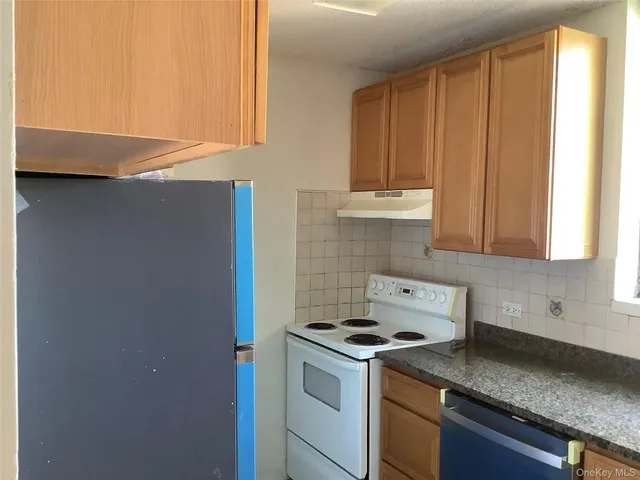 a kitchen with a stove and a cabinets