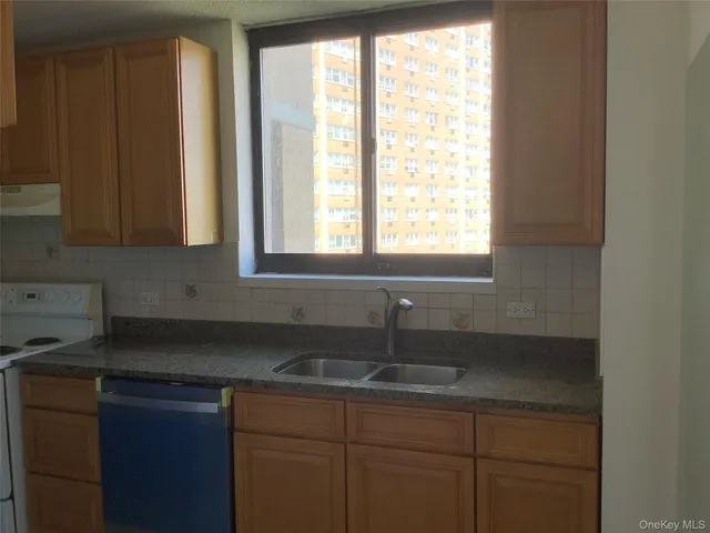 a kitchen with a sink cabinets and window