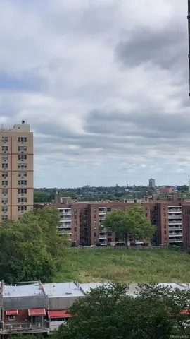 a view of a city with tall buildings and a big yard