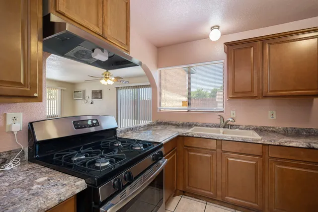 a kitchen with a sink stove and cabinets