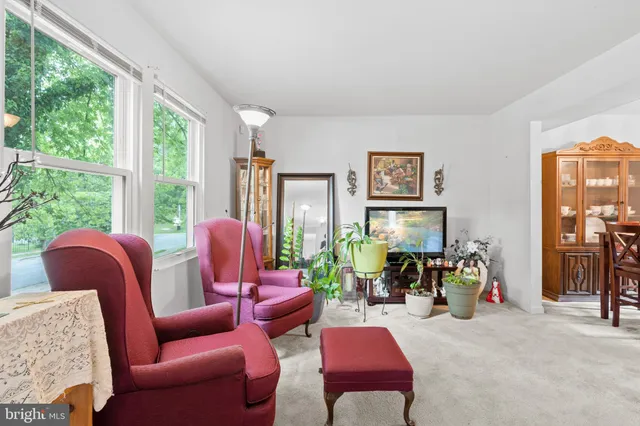 a living room with furniture and large windows