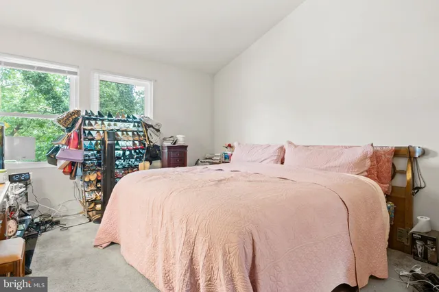 a bed sitting in a bedroom next to a large window