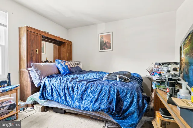 a bedroom with a bed and balcony view