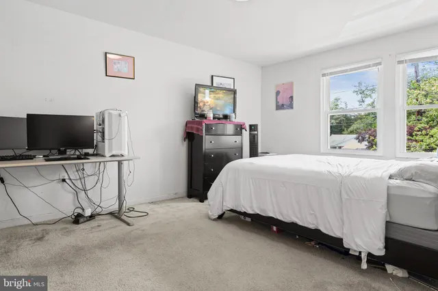 a bed room with furniture and a flat screen tv