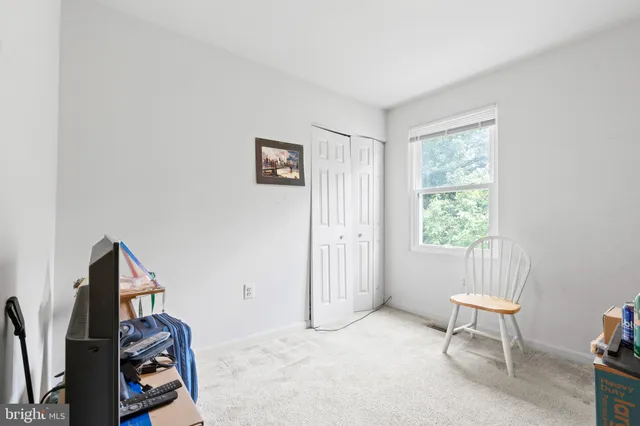 a view of a room with workspace and a window