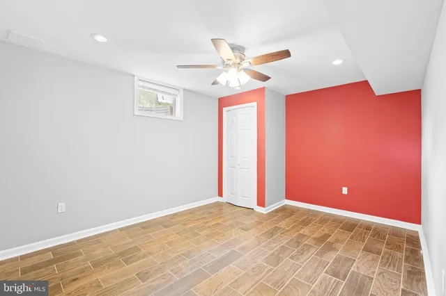 a view of a livingroom with a ceiling fan and window