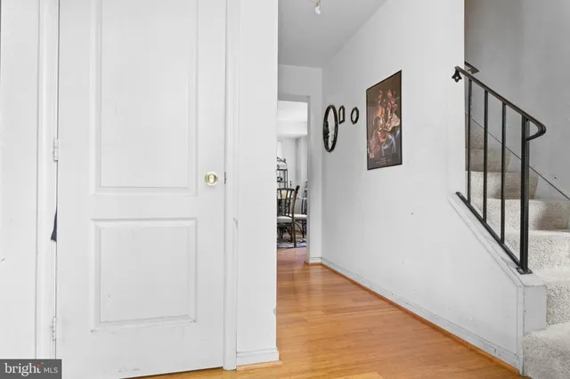 a view of a hallway with wooden floor and entryway