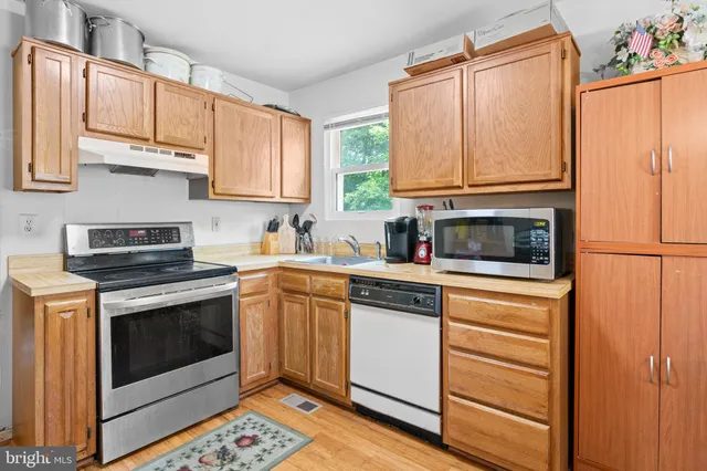 a kitchen with stainless steel appliances granite countertop a stove a microwave and a refrigerator