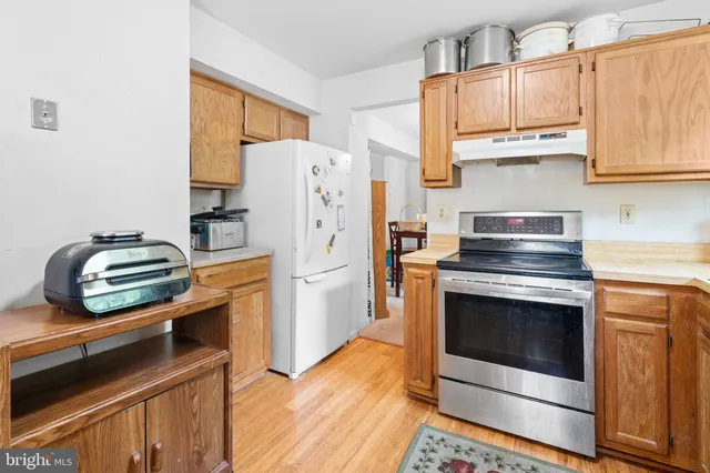 a kitchen with a stove and a refrigerator