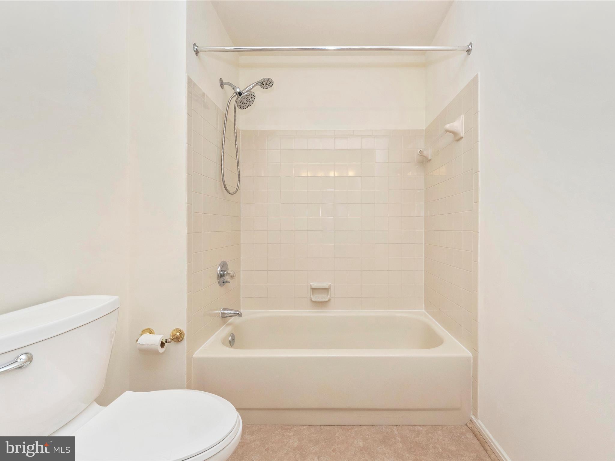 4214 Spring Avenue Halethorpe, MD 21227 - Photo 27 of 58 a bathroom with a toilet and a bathtub