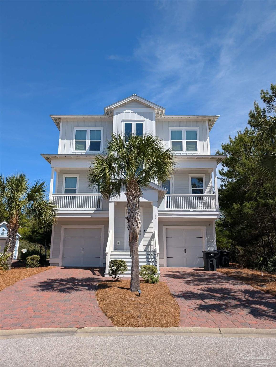 109 East Crabbing Hole Ln Inlet Beach Inlet Beach, FL 32461 - Photo 1 of 66 a front view of a house with a yard and garage