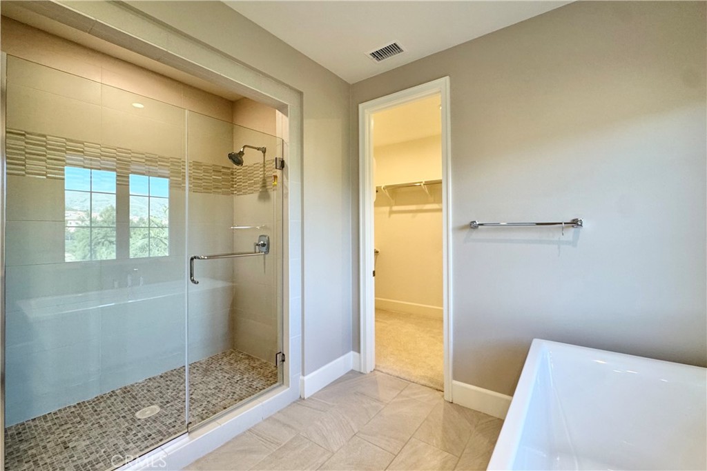 115 Locanda Irvine, CA 92602 - Photo 19 of 28 a bathroom with a tub and shower