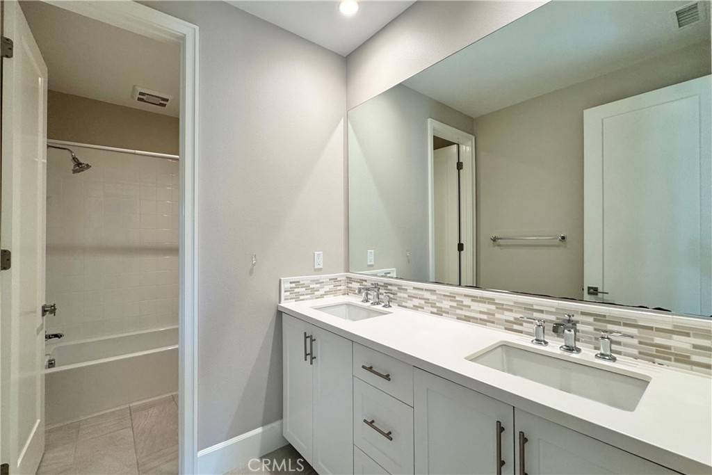 115 Locanda Irvine, CA 92602 - Photo 23 of 28 a bathroom with a sink and a mirror