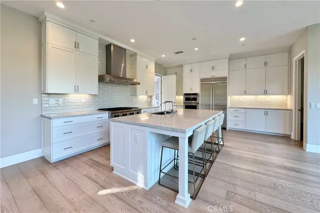 a kitchen with kitchen island a stove a sink and a refrigerator