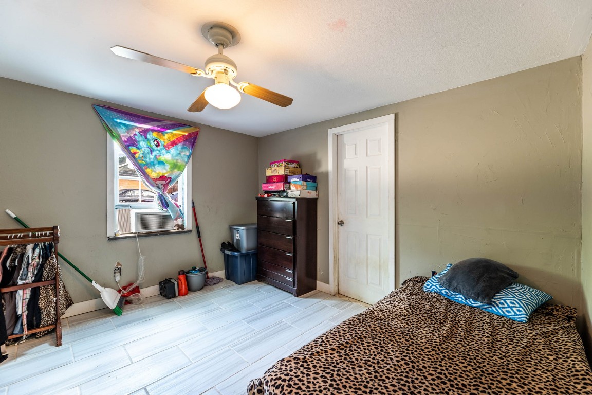 1144 Mason Avenue Austin, TX 78721 - Photo 35 of 37 a bedroom with a bed chandelier and a window