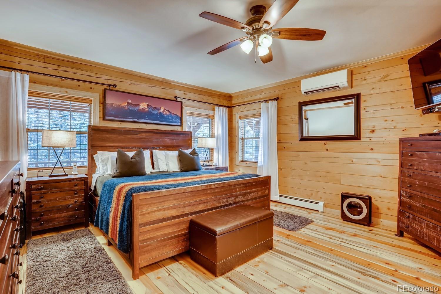 13380 South Foxton Road Conifer, CO 80433 - Photo 17 of 40 a bedroom with a bed and wooden floor