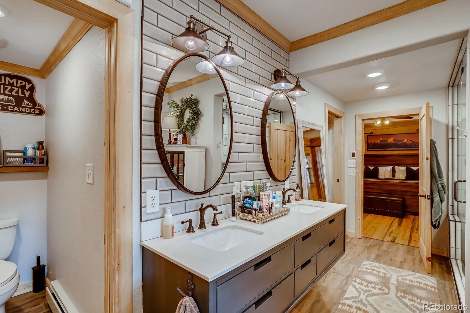 13380 South Foxton Road Conifer, CO 80433 - Photo 20 of 40 a bathroom with a sink mirror and a toilet