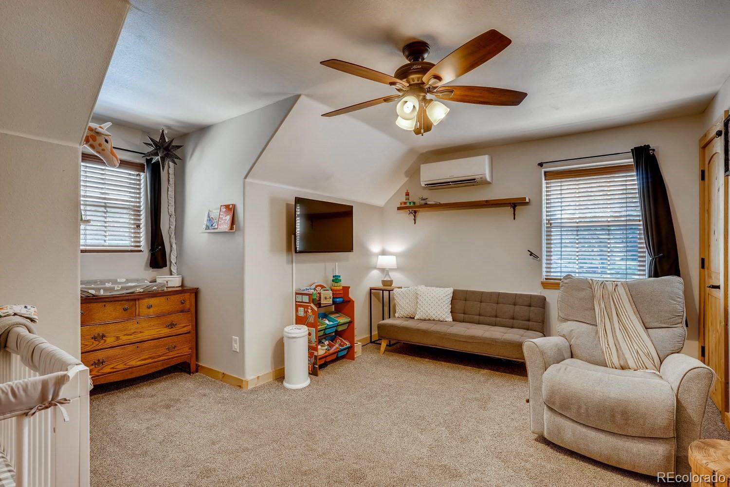 13380 South Foxton Road Conifer, CO 80433 - Photo 25 of 40 a living room with furniture and a flat screen tv