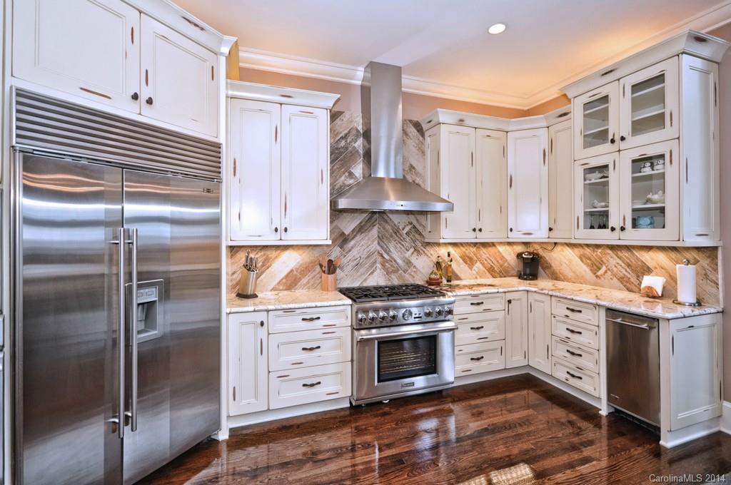 18301 Bowsprit Pointe Road Cornelius, NC 28031 - Photo 7 of 24 a kitchen with stainless steel appliances granite countertop a stove and a refrigerator