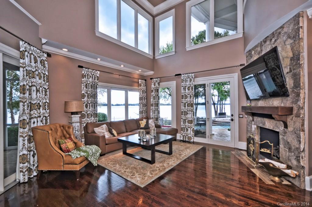 18301 Bowsprit Pointe Road Cornelius, NC 28031 - Photo 10 of 24 a living room with furniture a fireplace and a flat screen tv